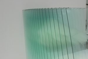 Abstract image showcasing a modern glass panel installation with reflections and a minimalistic design.